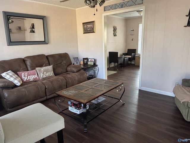 living room featuring a ceiling fan, baseboards, ornamental molding, and wood finished floors