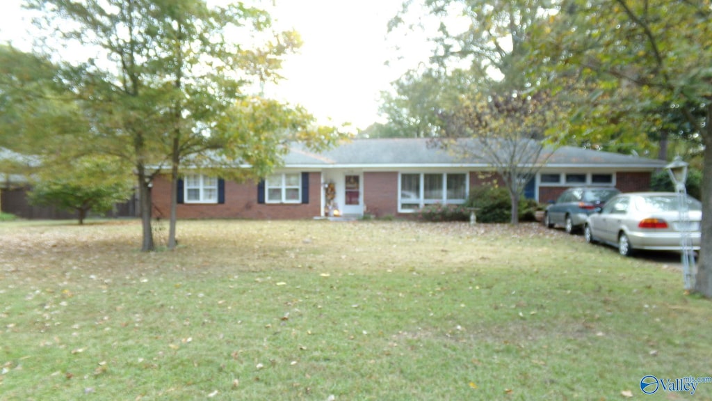 ranch-style house with a front yard and a garage