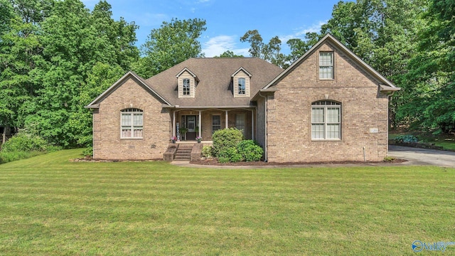 11266 Maggie Lou Dr, Tanner, AL 35671 - view of front facade featuring brick siding, a front yard, and a porch