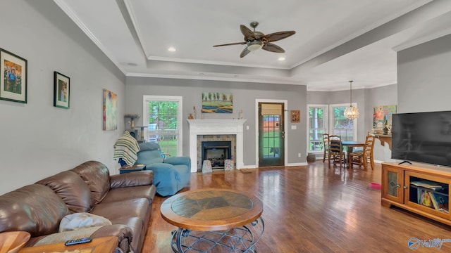 11266 Maggie Lou Dr, Tanner, AL 35671 - living area with a raised ceiling, wood finished floors, a ceiling fan, a fireplace with flush hearth, and ornamental molding