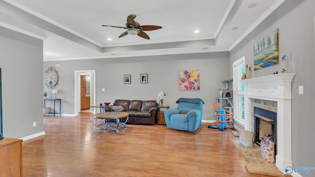 11266 Maggie Lou Dr, Tanner, AL 35671 - living room with ceiling fan, a raised ceiling, wood finished floors, baseboards, and crown molding