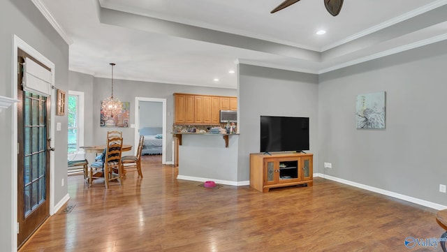 11266 Maggie Lou Dr, Tanner, AL 35671 - living room with a ceiling fan, wood finished floors, a tray ceiling, crown molding, and recessed lighting