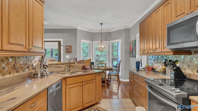 11266 Maggie Lou Dr, Tanner, AL 35671 - kitchen with stainless steel appliances, a sink, light stone counters, a peninsula, and backsplash