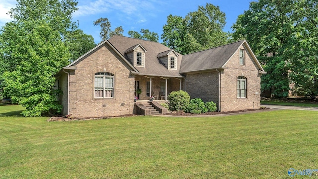 11266 Maggie Lou Dr, Tanner, AL 35671 - view of front facade featuring brick siding, covered porch, a front yard, and roof with shingles