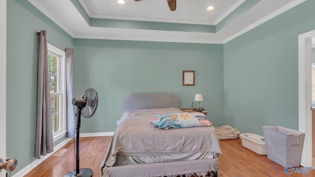 11266 Maggie Lou Dr, Tanner, AL 35671 - bedroom featuring wood finished floors, a tray ceiling, crown molding, a ceiling fan, and recessed lighting