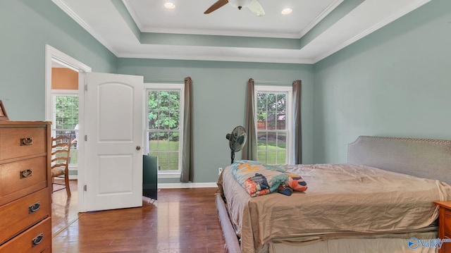 11266 Maggie Lou Dr, Tanner, AL 35671 - bedroom featuring dark wood-style flooring, a tray ceiling, ornamental molding, ceiling fan, and baseboards
