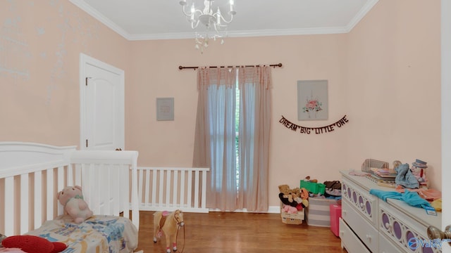 11266 Maggie Lou Dr, Tanner, AL 35671 - bedroom featuring a chandelier, wood finished floors, ornamental molding, and a nursery area