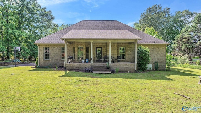 11266 Maggie Lou Dr, Tanner, AL 35671 - back of house with brick siding, a lawn, a porch, and roof with shingles