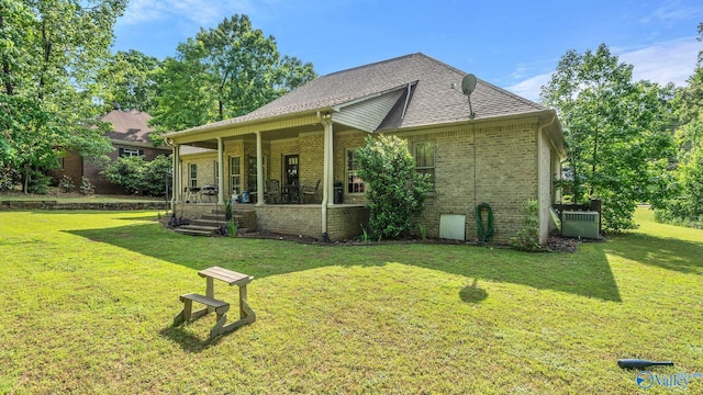 11266 Maggie Lou Dr, Tanner, AL 35671 - view of home's exterior featuring a porch, a lawn, brick siding, and central air condition unit