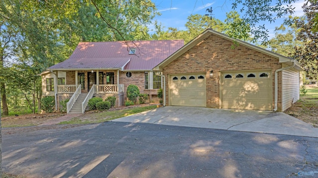 17207 County Road 22, Centre, AL 35960 - view of front of home with driveway, brick siding, a porch, metal roof, and stairs