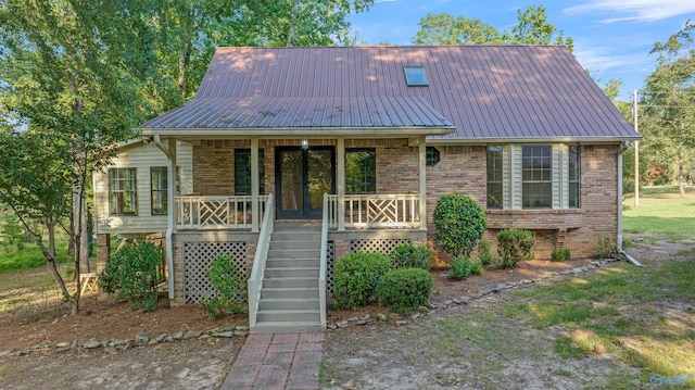 17207 County Road 22, Centre, AL 35960 - view of front of property with metal roof, covered porch, stairs, and brick siding