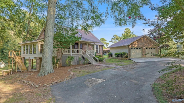 17207 County Road 22, Centre, AL 35960 - view of front of house with stairs, a detached garage, metal roof, covered porch, and an outbuilding