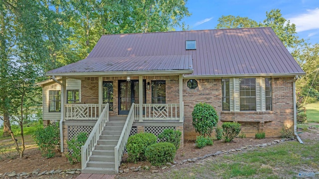 17207 County Road 22, Centre, AL 35960 - view of front of property with a porch, metal roof, brick siding, and stairs