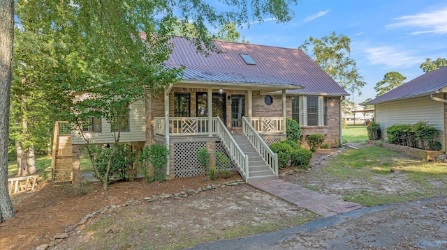 17207 County Road 22, Centre, AL 35960 - view of front of house featuring covered porch, stairs, brick siding, and metal roof