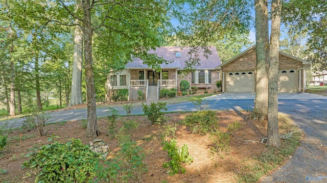 17207 County Road 22, Centre, AL 35960 - view of front of house with concrete driveway, metal roof, brick siding, and a porch