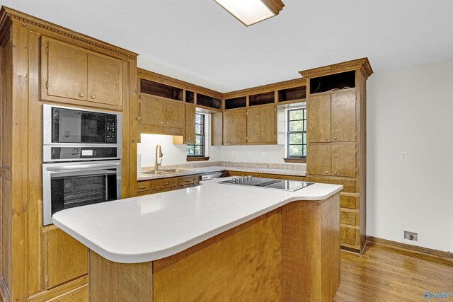 17207 County Road 22, Centre, AL 35960 - kitchen featuring black appliances, light wood-style flooring, light countertops, a kitchen island, and baseboards