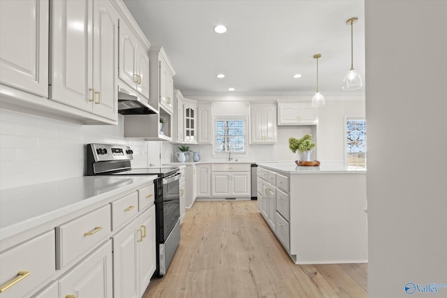 kitchen with appliances with stainless steel finishes, crown molding, sink, white cabinetry, and hanging light fixtures