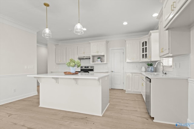 kitchen featuring a center island, sink, white cabinets, and stainless steel appliances