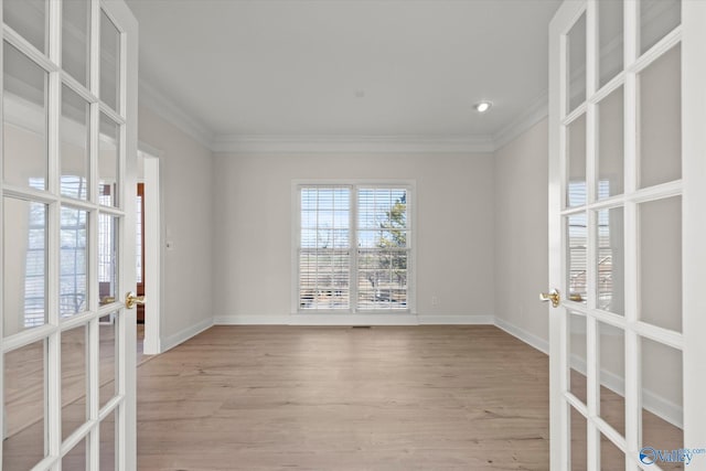 unfurnished room with french doors, light wood-type flooring, and ornamental molding