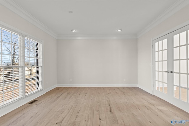 spare room with light hardwood / wood-style floors, ornamental molding, and french doors