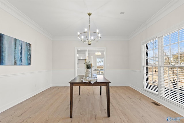home office with ornamental molding, light hardwood / wood-style flooring, and a chandelier
