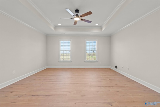 unfurnished room featuring light hardwood / wood-style flooring, crown molding, and a tray ceiling