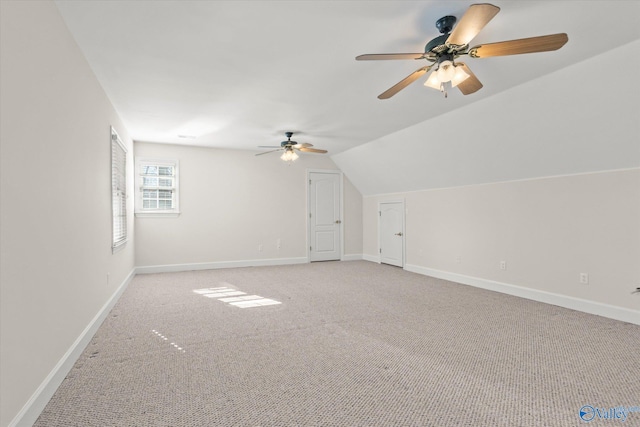 additional living space featuring light carpet, ceiling fan, and vaulted ceiling