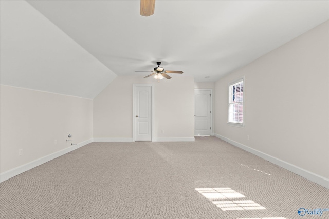 additional living space with light colored carpet, ceiling fan, and lofted ceiling