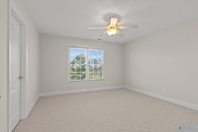 unfurnished room with ceiling fan and light carpet