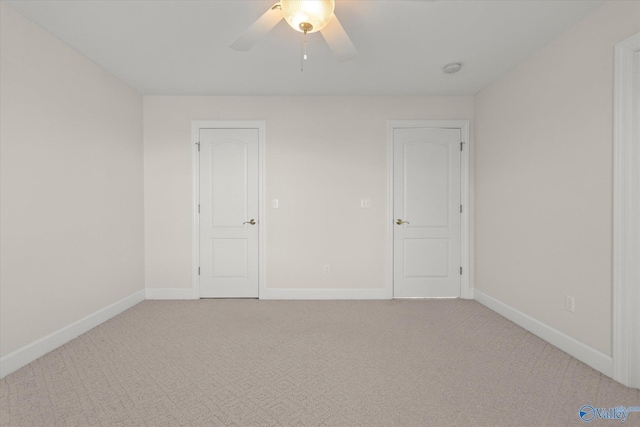 empty room with ceiling fan and light colored carpet