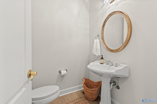 bathroom featuring hardwood / wood-style floors and toilet