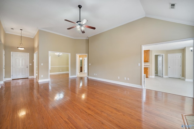 unfurnished living room with crown molding, light hardwood / wood-style flooring, ceiling fan with notable chandelier, and a towering ceiling