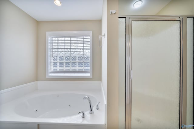 bathroom featuring shower with separate bathtub