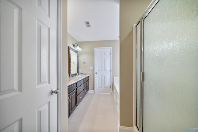 bathroom featuring tile patterned floors, vanity, and separate shower and tub