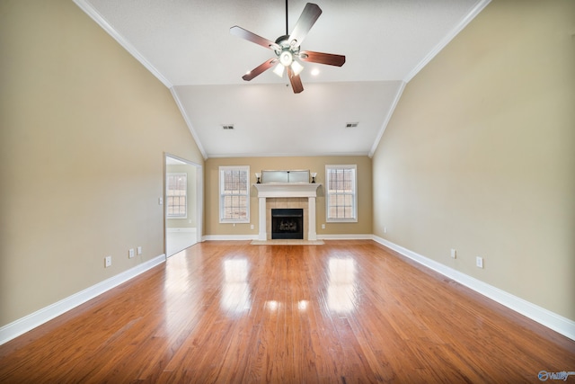 unfurnished living room featuring a fireplace, lofted ceiling, ceiling fan, light hardwood / wood-style floors, and crown molding