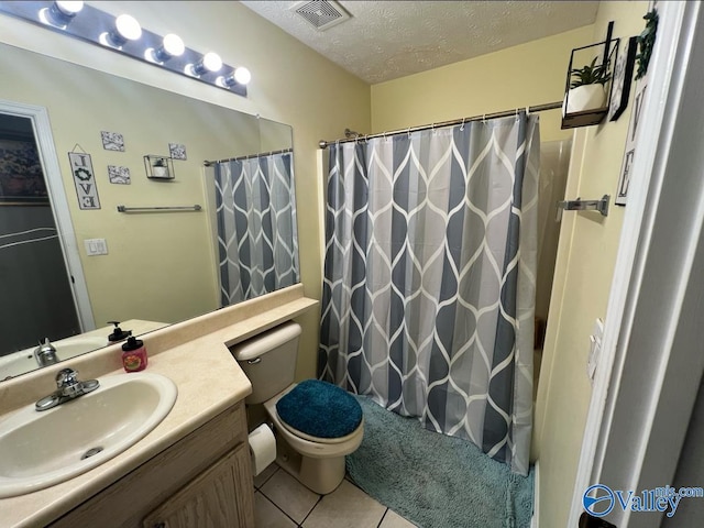 bathroom featuring vanity, walk in shower, tile patterned flooring, toilet, and a textured ceiling