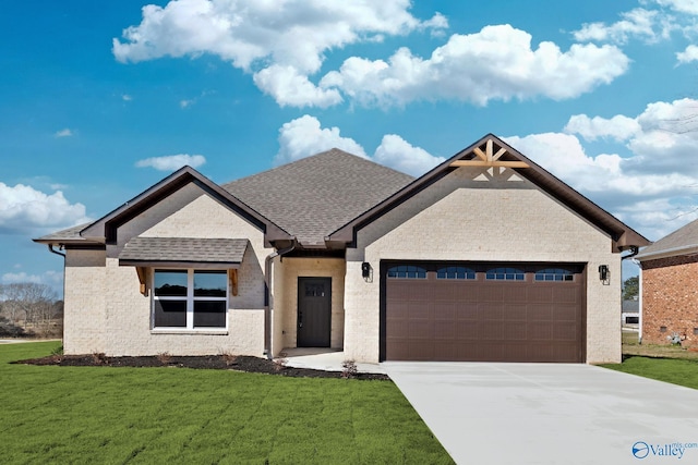 view of front of house featuring a front yard, a garage, brick siding, driveway, and roof with shingles