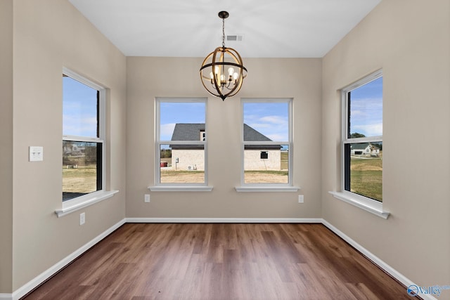 unfurnished dining area with visible vents, an inviting chandelier, and a healthy amount of sunlight