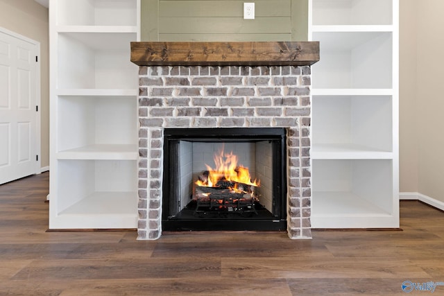details with built in features, wood finished floors, and a fireplace