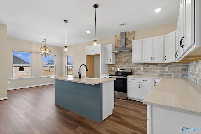 kitchen featuring a sink, wall chimney range hood, white cabinetry, stainless steel electric range, and dark wood-type flooring