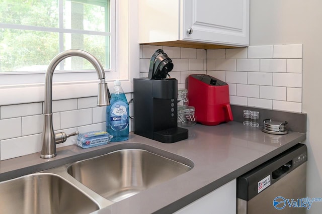 interior details featuring a sink, tasteful backsplash, white cabinets, and dishwasher