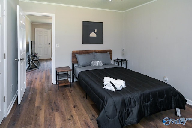 bedroom featuring ornamental molding and wood finished floors