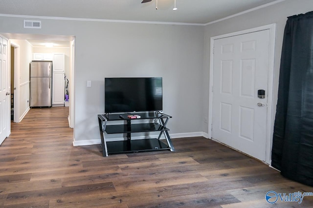 living area with baseboards, visible vents, dark wood finished floors, and ornamental molding