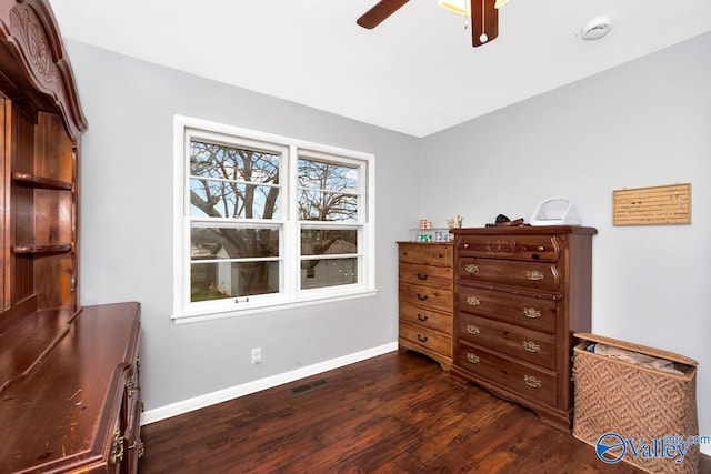 interior space featuring dark wood finished floors, baseboards, visible vents, and a ceiling fan