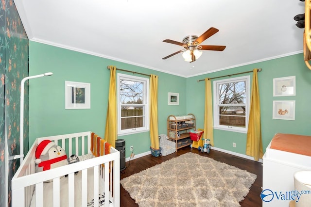 bedroom with multiple windows, a nursery area, ornamental molding, and dark wood-type flooring