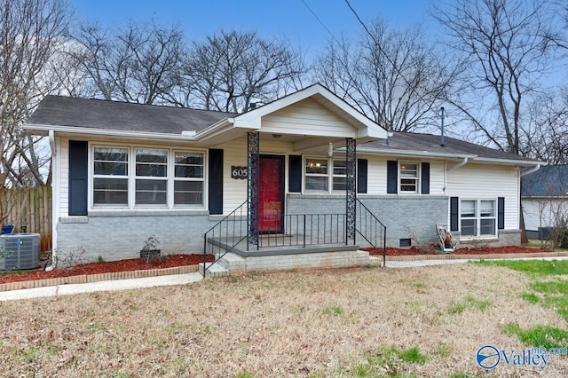 view of front facade featuring cooling unit and brick siding