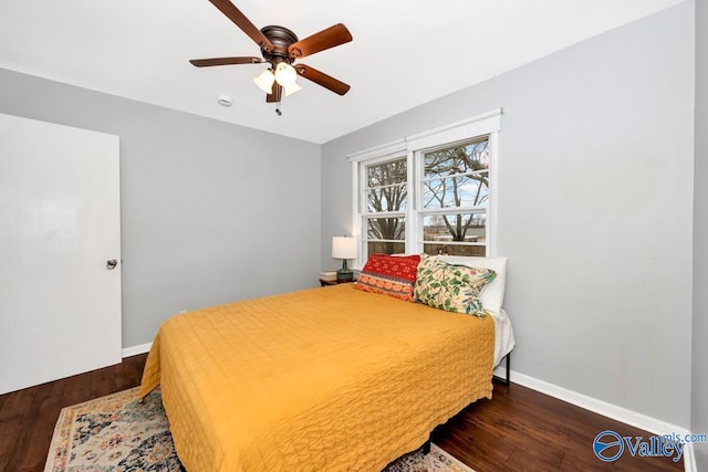 bedroom with ceiling fan, baseboards, and wood finished floors