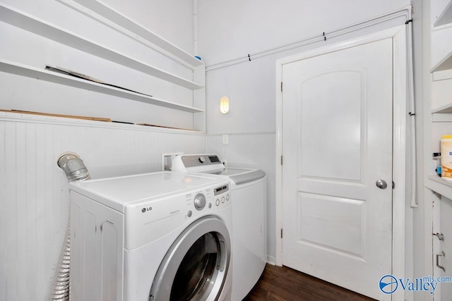 washroom with washer and dryer, laundry area, dark wood finished floors, and wainscoting