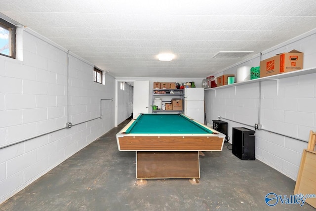 game room featuring concrete block wall, concrete flooring, and billiards