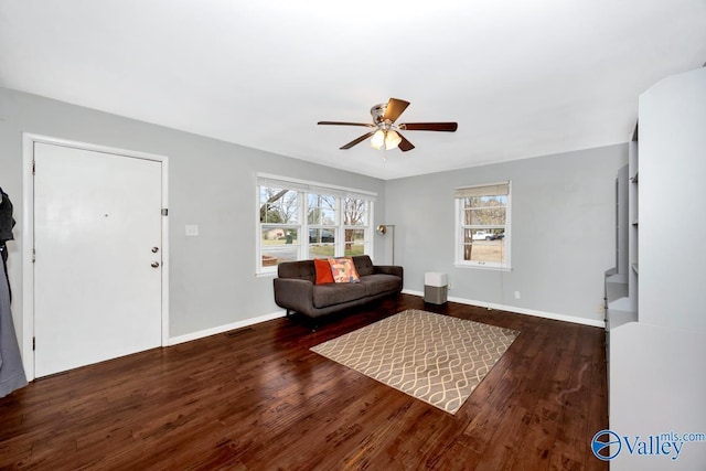 interior space with visible vents, baseboards, wood finished floors, and a ceiling fan